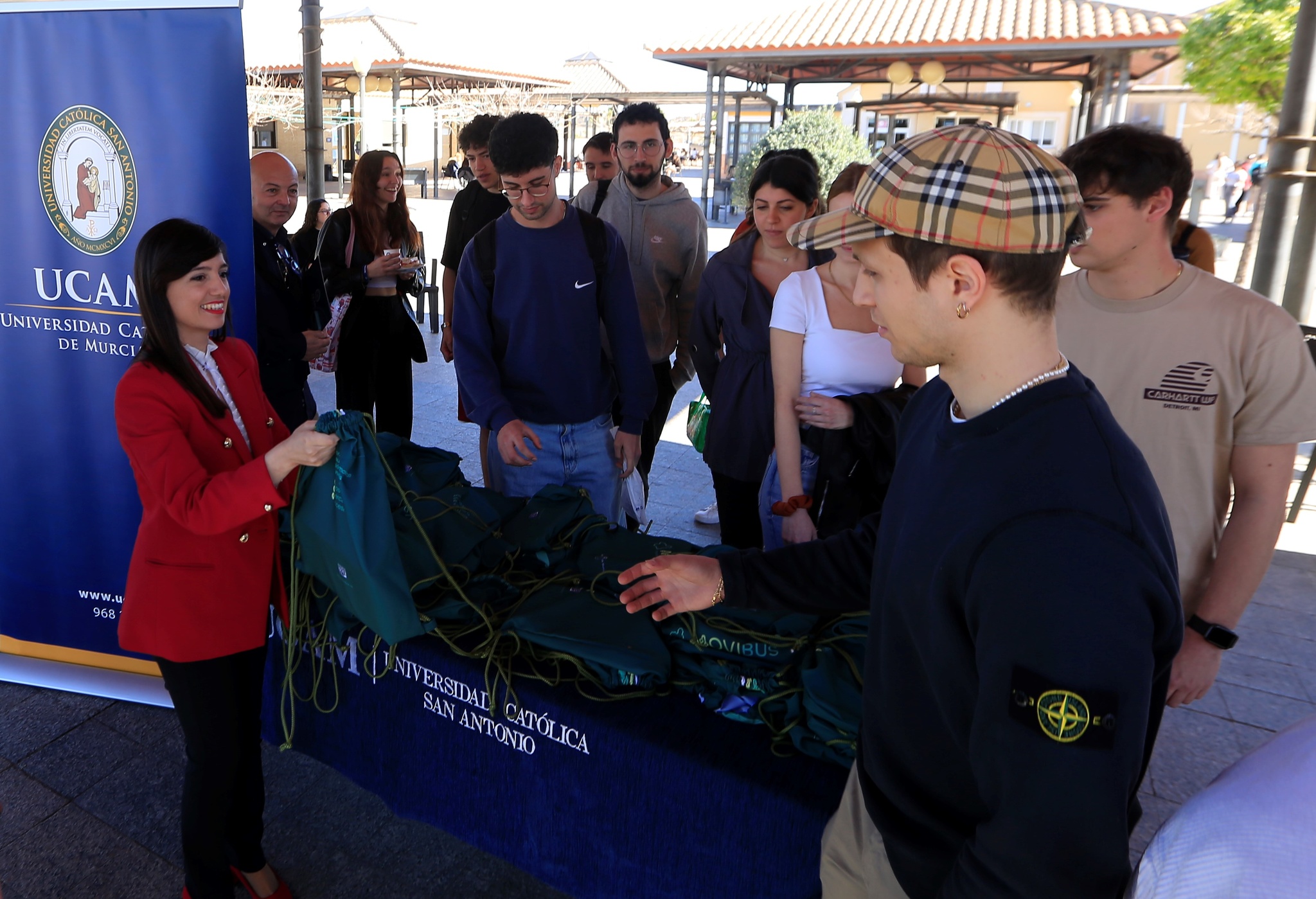 La directora general de Movilidad y Litoral, Marina Munuera, junto con el vicedecano del Grado en Ingeniería Civil de la UCAM, Pedro de los Santos Jiménez, promociona el nuevo modelo de transporte público 'Movibus' entre los estudiantes del centro universitario