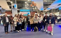 La consejera Carmen Conesa y el director del Instituto de Turismo, con un grupo de estudiantes de Turismo ante el estand de la Región en Fitur.