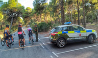 Agentes medioambientales se dirigen a unos ciclistas en el entorno de un parque regional para hacerles indicaciones.