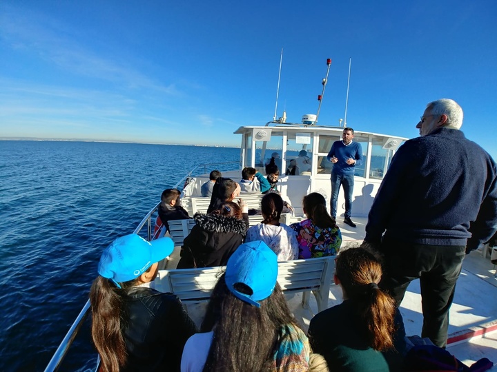 Los alumnos del Centro de Educación Infantil y Primaria La Asomada atienden a la exposición del director general de Medio Ambiente, Antonio Luengo, y del investigador Ángel Pérez Ruzafa durante una ruta ambiental en barco por el Mar Menor